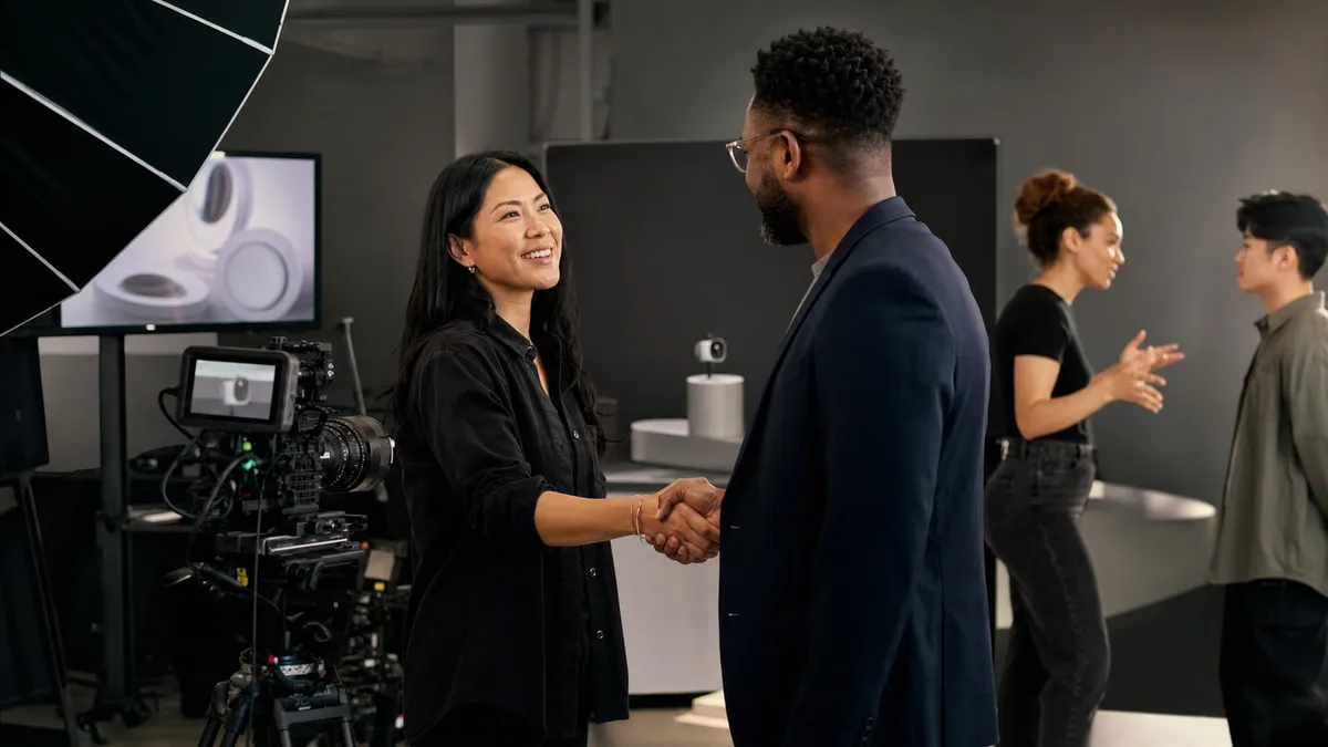 Creative director shaking hands with a business marketer on a product video set